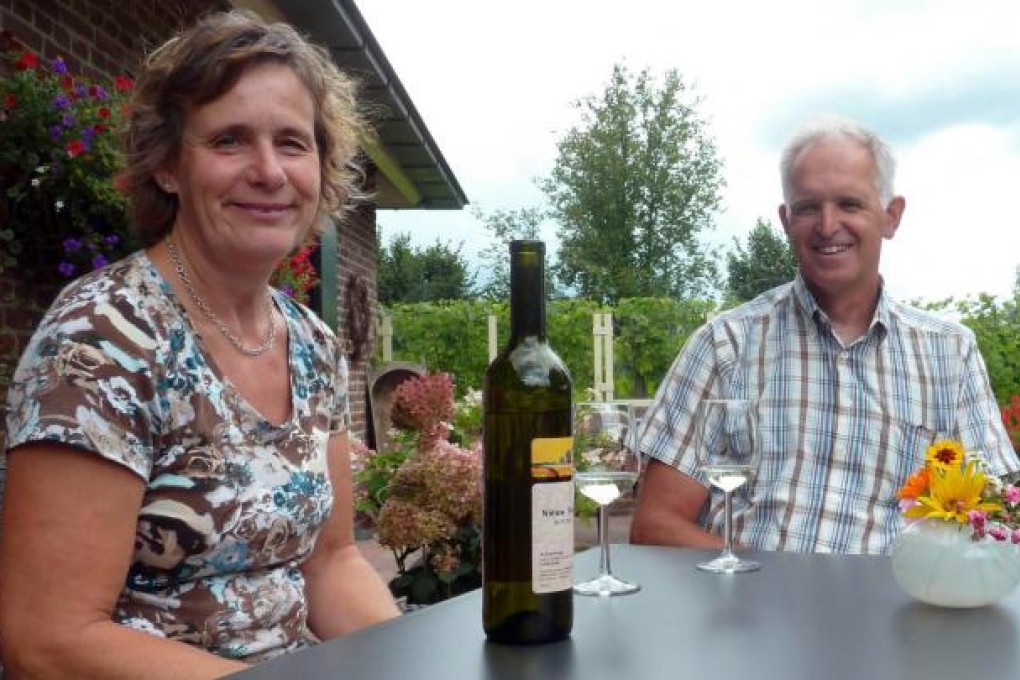 Job and Neeltje Huisman drink a Nieuw Tivoli 2011, a white wine produced from the special grapes in their vineyards. Photo: AFP