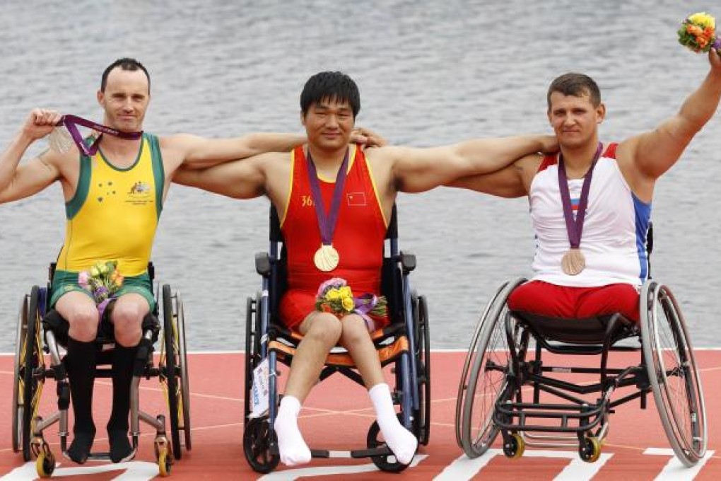 Huang Cheng wins gold, with Australia'a Erik Horrie with silver (left) and Russia's Aleksey Chuvashev with bronze. Photo: AFP