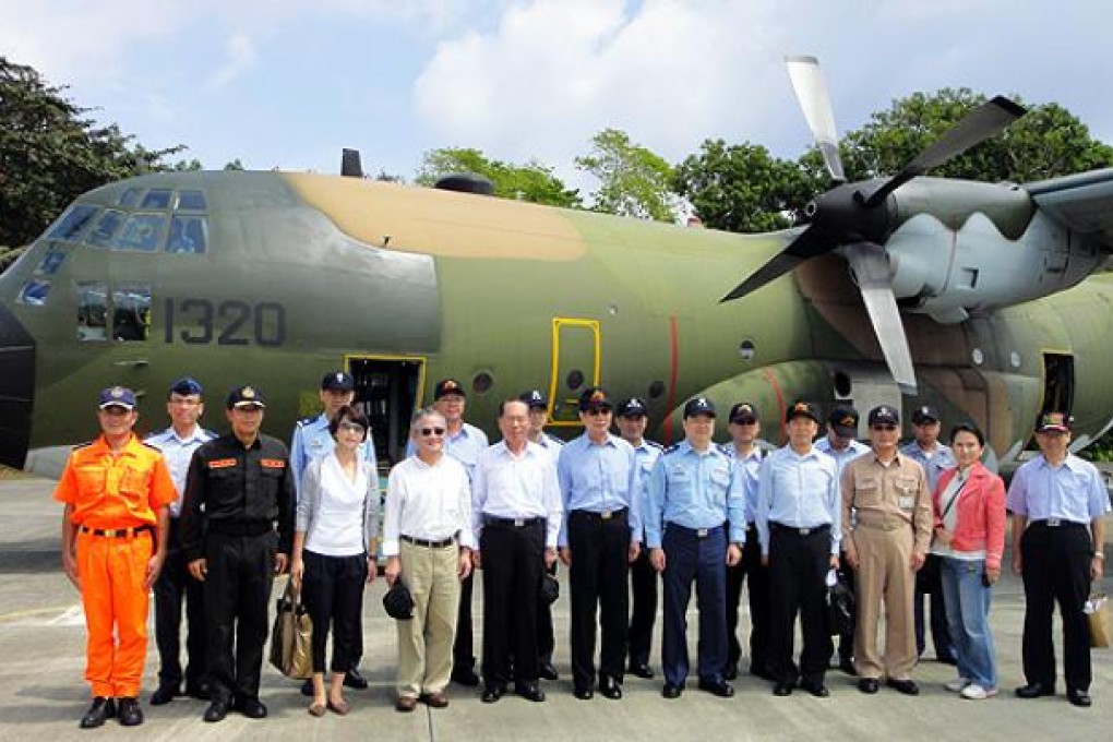 Three Taiwanese lawmakers, defence officials and members of the coastguard land on the island of Taiping in the Spratleys on Tuesday. Photo: AFP