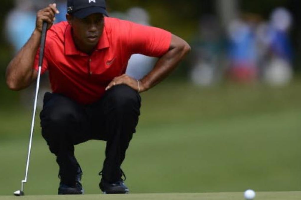 Tiger Woods lines up his putt on the first hole of the final round at the Deutsche Bank Championship on Monday. Photo: EPA