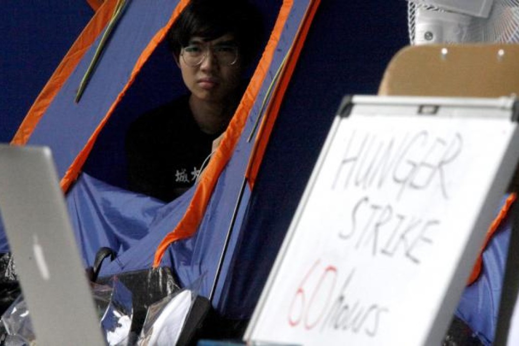 Student activists continue hunger strikes in education protest outside Hong Kong Government headquarters. Photo: EPA