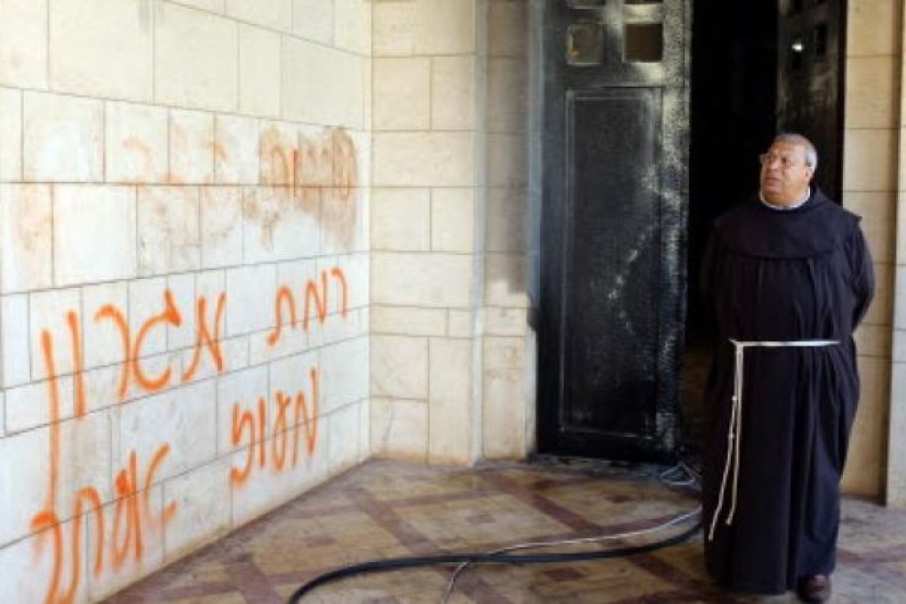 Abdel Maseru, a Franciscan monk from Jaffa visits the Trappist Monastery at Latroun, Israel, on Tuesday, where graffiti was spray painted and a door set ablaze. Photo: EPA