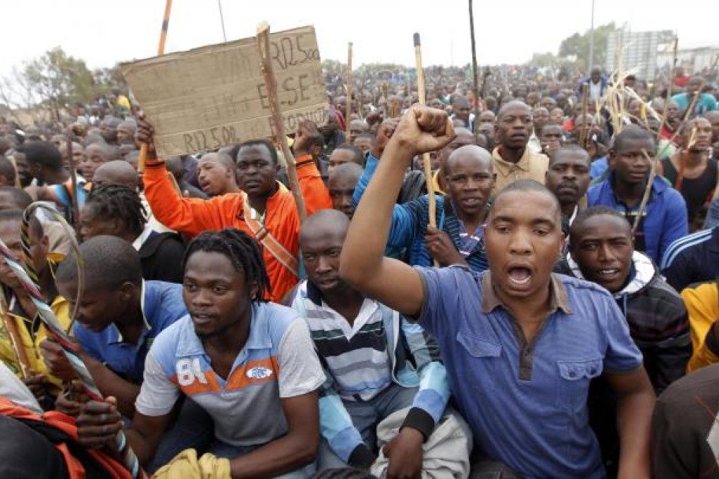 Thousands of striking miners from the Lonmin platinum mine march to the gates of the Karee Mine as part of their mass action. Photo: EPA