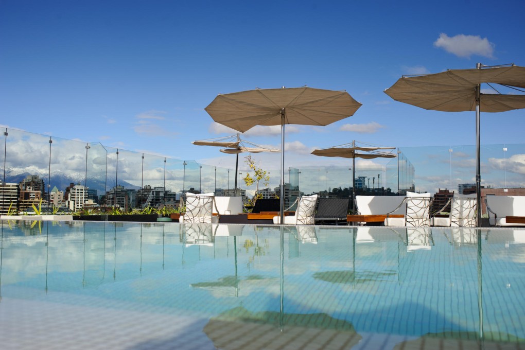 The rooftop pool at Hotel Noi Vitacura (above); a fish stall at the Mercado Central (below), where many restaurants are located