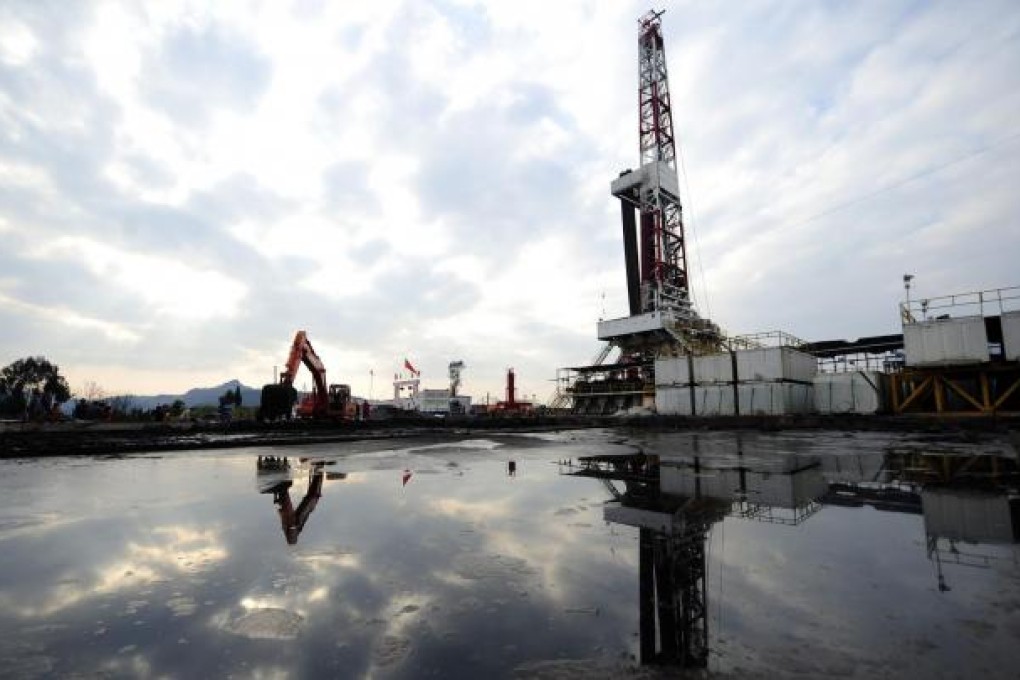 A natural gas appraisal well is seen behind a treatment pond of drilling waste. Honghua Group is seeking the technology to unlock gas trapped in rock formations. Photo: Reuters