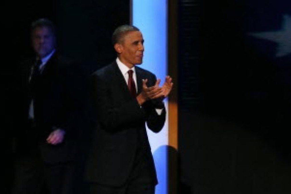 US President Barack Obama walks on to the stage after Former US President Bill Clinton speaks during day two of the Democratic National Convention. Photo: AFP