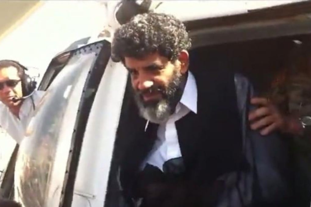 A video grab shows Abdullah al-Senussi arriving at the high security prison facility in Tripoli on Wednesday. Photo: AFP