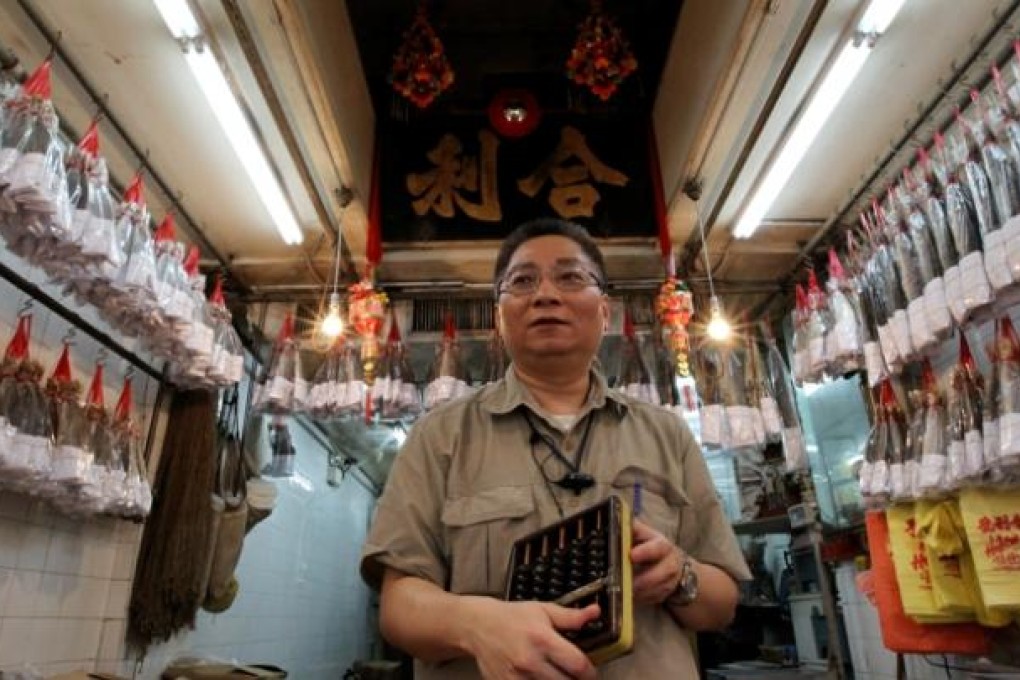 Au Chun-pang, owner of Hop Lee Ho Sea Products, auctions salted fish in Sai Ying Pun. Photo: Edward Wong