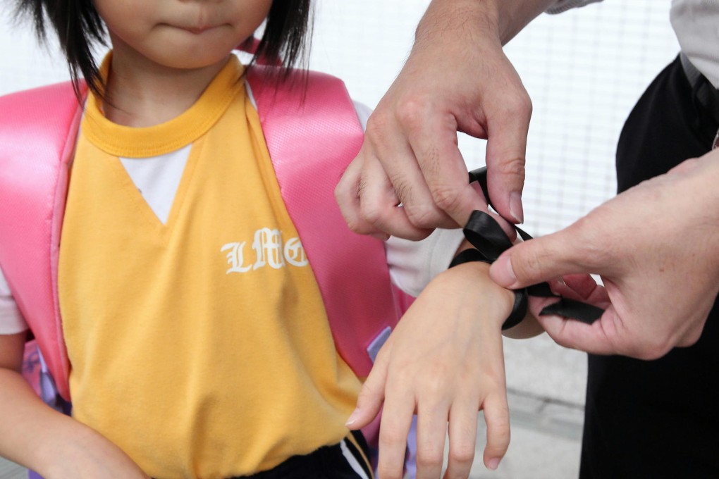 A pupil with a black protest ribbon outside Baptist Lui Ming Choi Primary School in Sha Tin. Others wore black clothes. Photo: Felix Wong