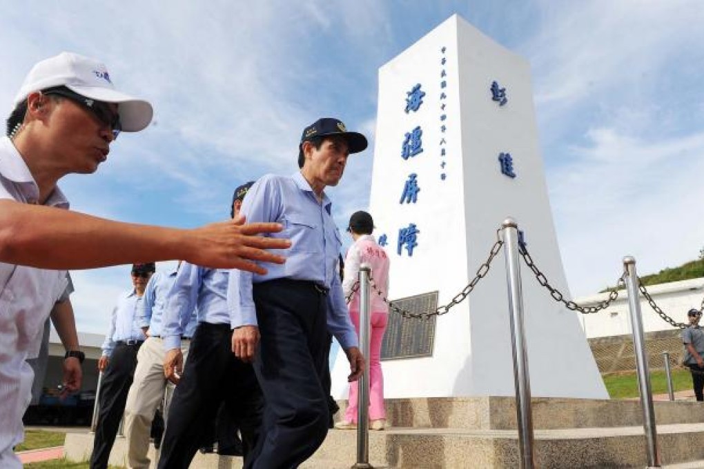 Taiwan President Ma Ying-jeou walks by a monument during an inspection of the Pengjia Islet in the East China Sea yesterday. Photo: AFP
