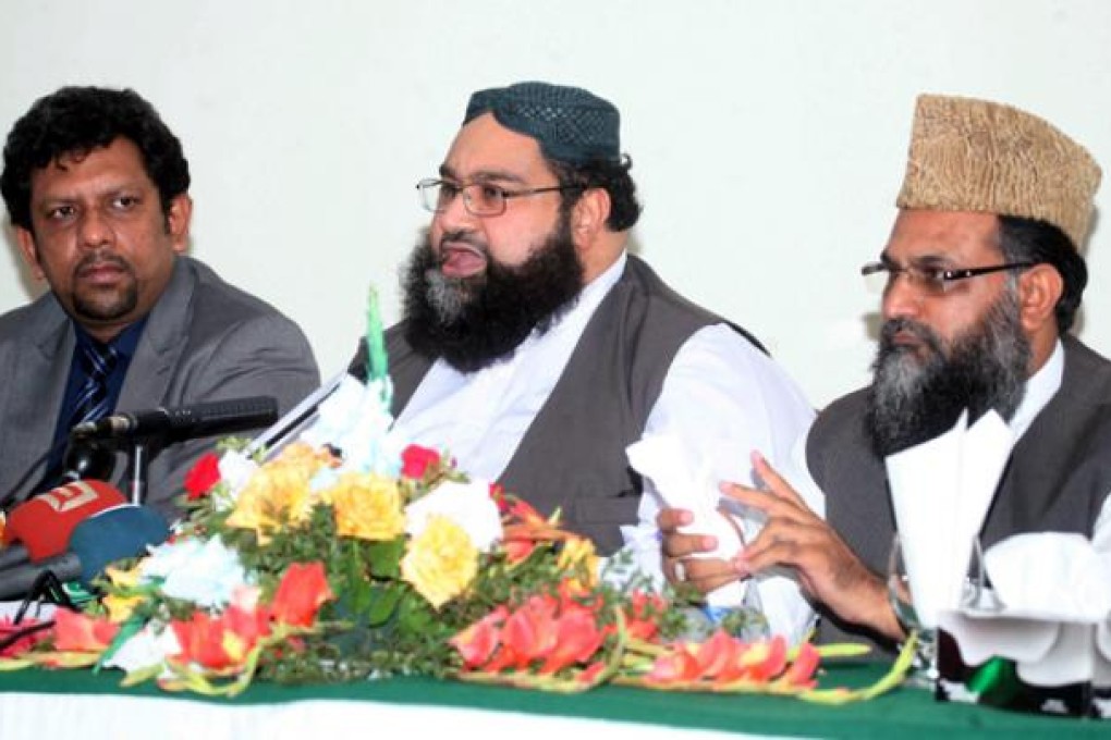 Tahir Ashrafi, centre, chairman of the All Pakistan Ulema Council, addresses a press conference in Islamabad on Monday. Ashrafi urged the government to set up a team, including intelligence agents, to get to the bottom of the conspiracy and expose the real culprits' in the Rimsha Masih case. Photo EPA