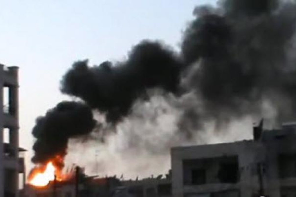 A building on fire after a shelling in the city of Aleppo. Syrian troops backed by tanks and helicopters repelled a rebel attack on an army base in Aleppo on Saturday after a 20-hour battle. Photo: EPA