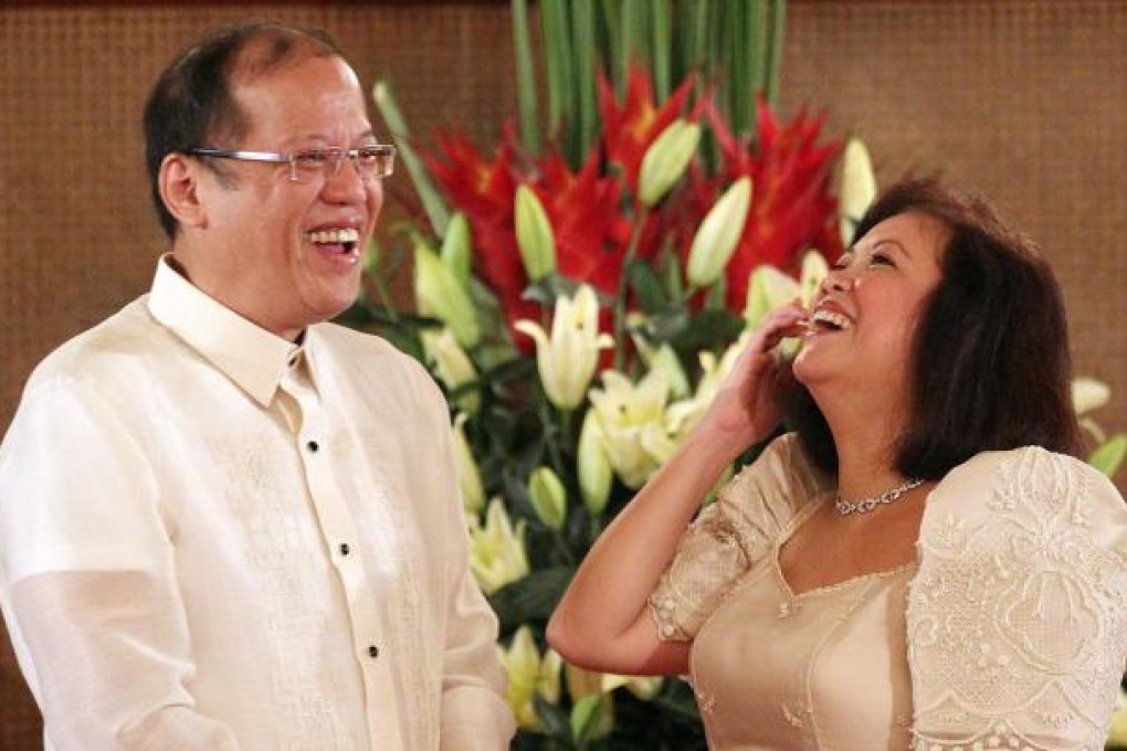 Maria Sereno laughs with President Benigno Aquino after taking her oath as chief justice. Photo: EPA