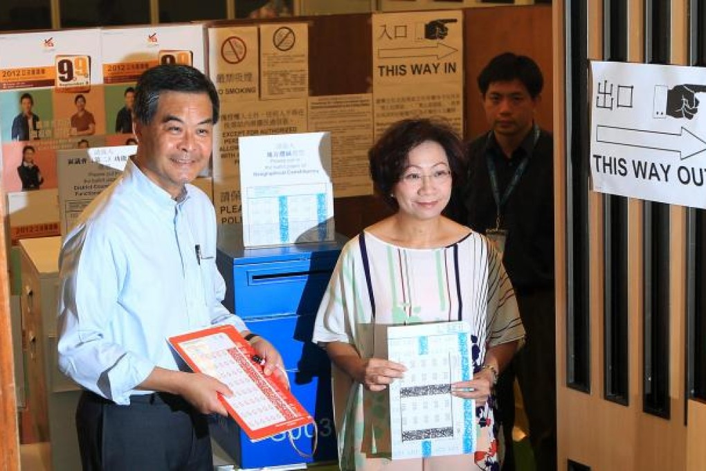 Chief Executive Leung Chun-ying and his wife, Regina (right), vote at the German Swiss International School on The Peak. Photo: Jonathan Wong