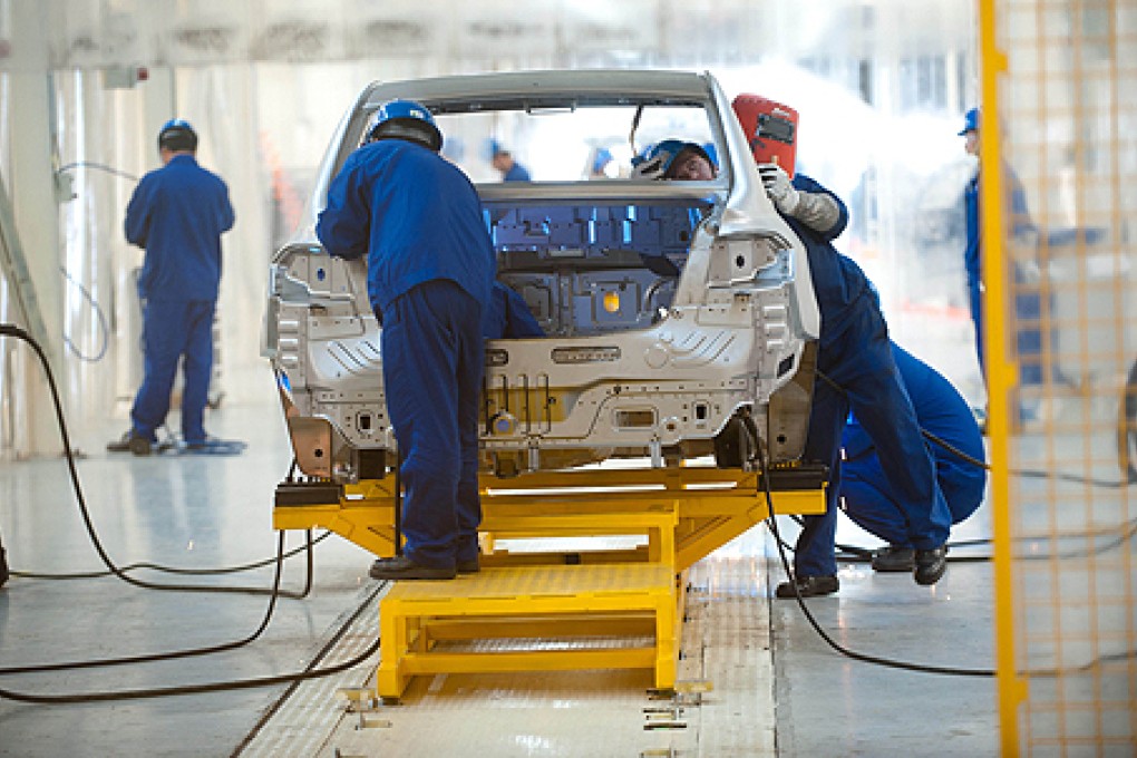 Workers assemble a car in an automobile factory in Beijing. China reported weak growth in industrial output in August. Photo: AFP