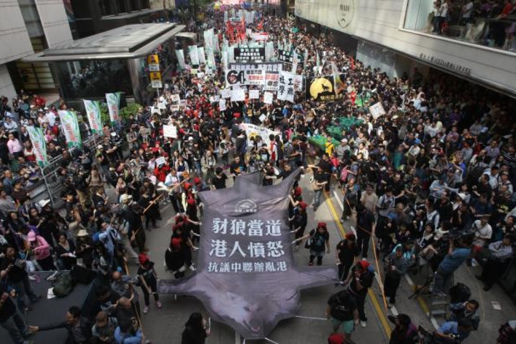 Civil Human Rights Front and pan-democrats hold for a protest against Chief Executive elect Leung Chun-ying and urge for universal suffrage march to Liaison office from Charter Garden. Photo: Sam Tsang