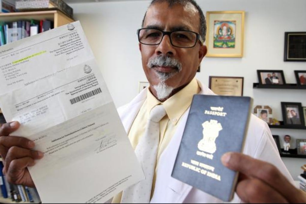 Professor Kumta with his Indian passport and the letter saying his application for Chinese citizenship has failed. Photo: Felix Wong