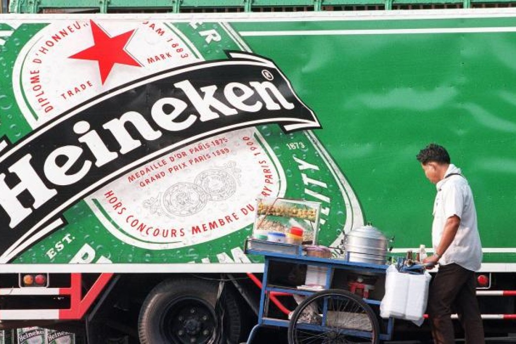 Fraser and Neave shareholders bote on proposed sale of a 40 per cent stake in Tiger beer maker Asia Pacific Breweries to Heineken later this month. Photo: AFP