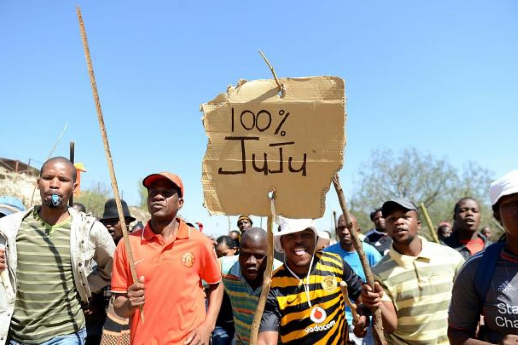 Striking miners listen to Julius Malema's speech. Photo: AP