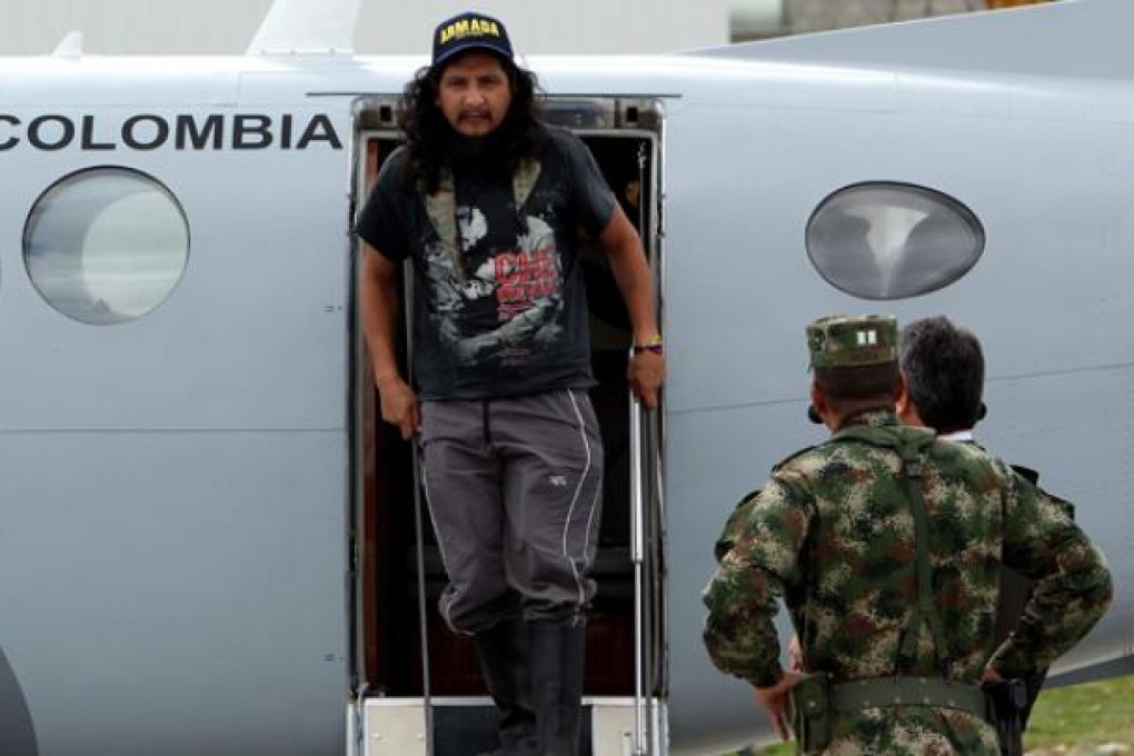 Ecuadorean citizen Orlando Sigifredo Ibarra Sarmiento exits a military airplane in Bogota on Monday. Photo: EPA