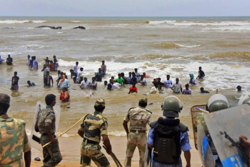 Indian policemen line up to control residents protesting against the Russian built Kudamkulam nuclear plant on the Bay of Bengal coast on Monday. Photo: AP