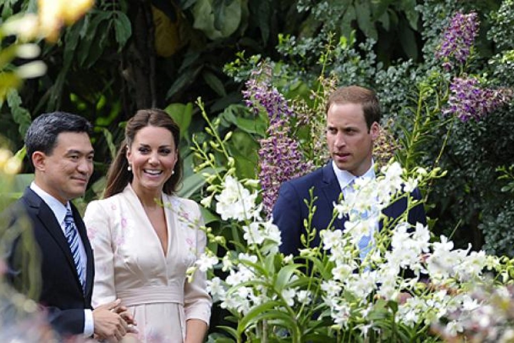 Prince William (right) and Catherine take a tour of Singapore’s Botanic Gardens with Poon Hong Yuen of the National Parks Board. An orchid will be named after the couple. Photo: EPA