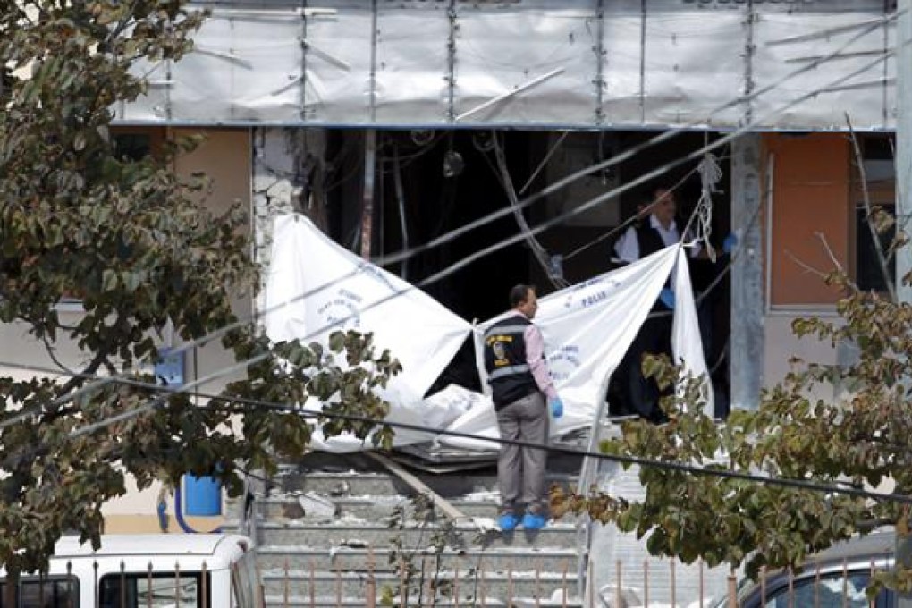 Turkish forensic officers search for evidence at the area after an explosion at Gazi Police station in Sultangazi district in Istanbul on Tuesday. Photo: EPA