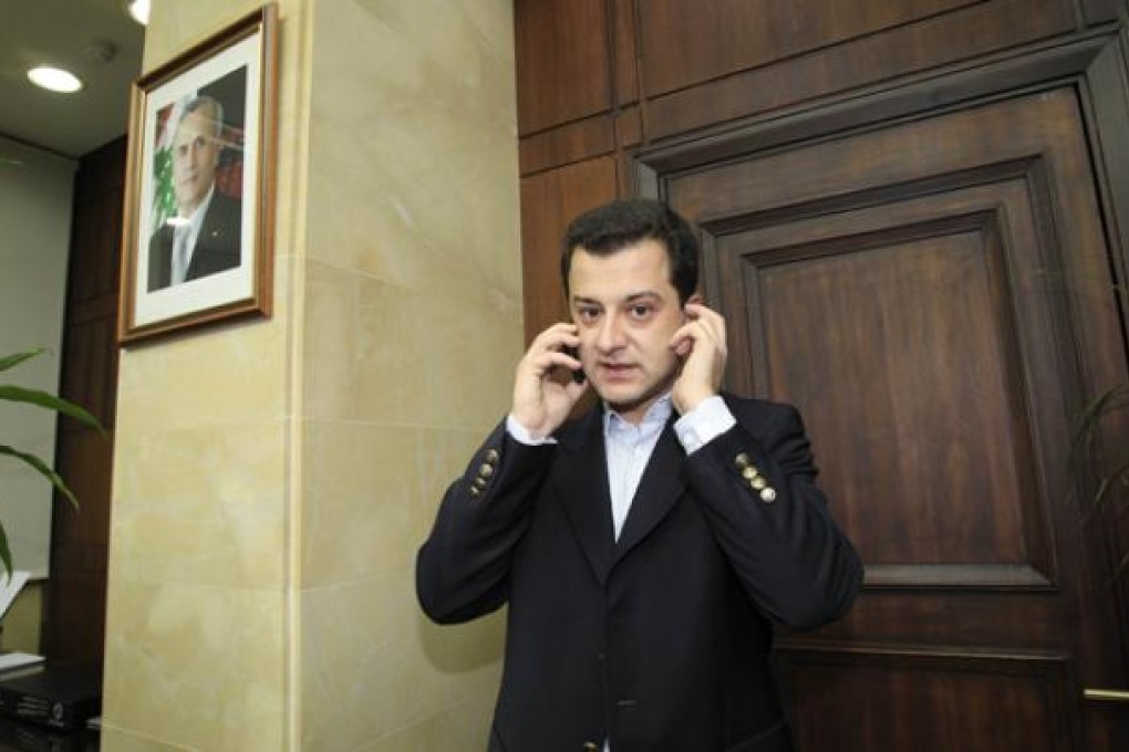 Turkish national Aydin Tufan Tekin, who was abducted by gunmen of Lebanon's Muqdad clan, phones after being handed to the Turkish Ambassador to Lebanon at the Lebanese General Security headquarters in Beirut on Tuesday. Photo: AFP