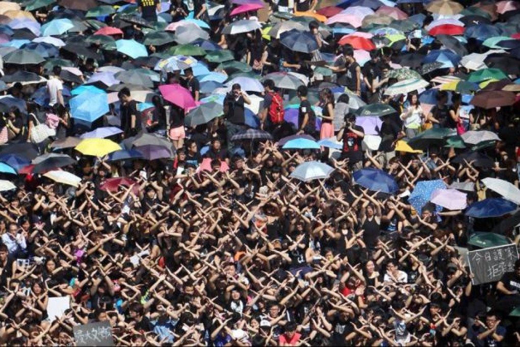 Students cross their arms to indicate a "No" to national education during the rally at Chinese University in Sha Tin. Photo: Felix Wong