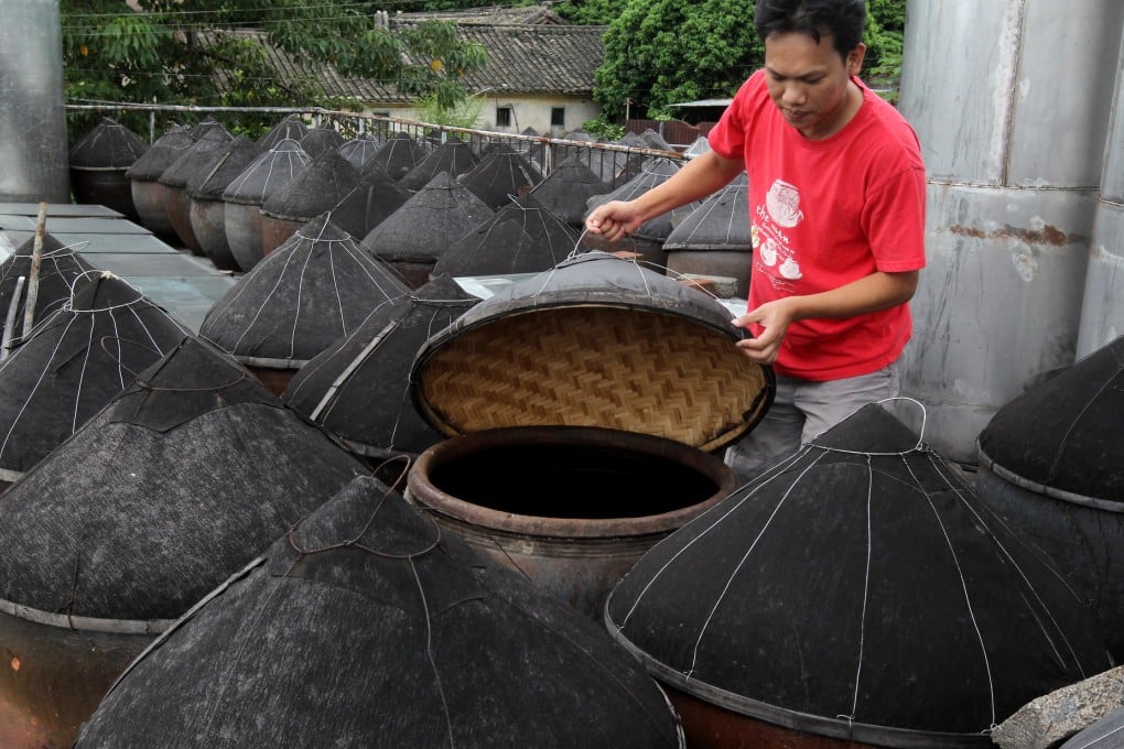 A worker checks vats at one of Kwu Tung's soy sauce factories. Photo: K.Y. Cheng