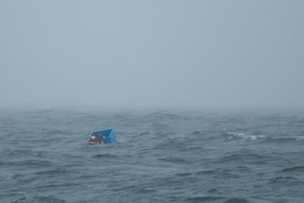 Ryan Harris's ordeal ends as a rescuer approaches. Photo: AP