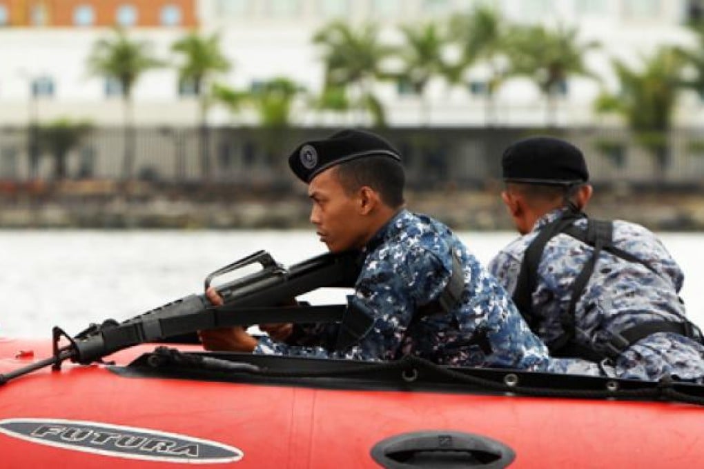 An anti-terrorist unit in the Philippines patrols waters near the US embassy in Manila. The US stepped up security outside US embassies across Asia. Photo: EPA