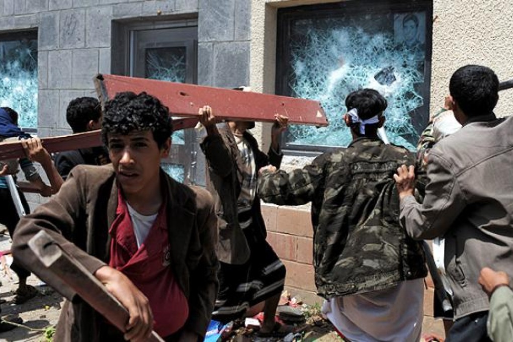 Yemeni protesters ransack the US embassy in Sanaa on Thursday. Photo: EPA
