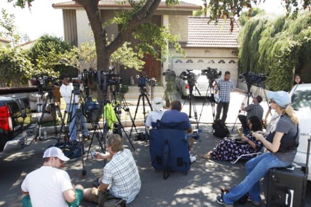Reporters gather outside the house of a man thought to be associated with the production of the anti-Muslim movie, 'Innocence of Muslims', on Thursday in Cerritos, California. Photo: AFP