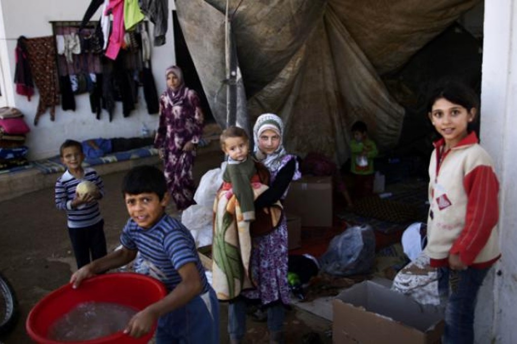 Syrian children, who fled their homes due to government shelling, take refuge with their families at Bab Al-Salameh crossing border, hoping to cross to one of the refugee camps in Turkey, near the Syrian town of Azaz. Photo: AP