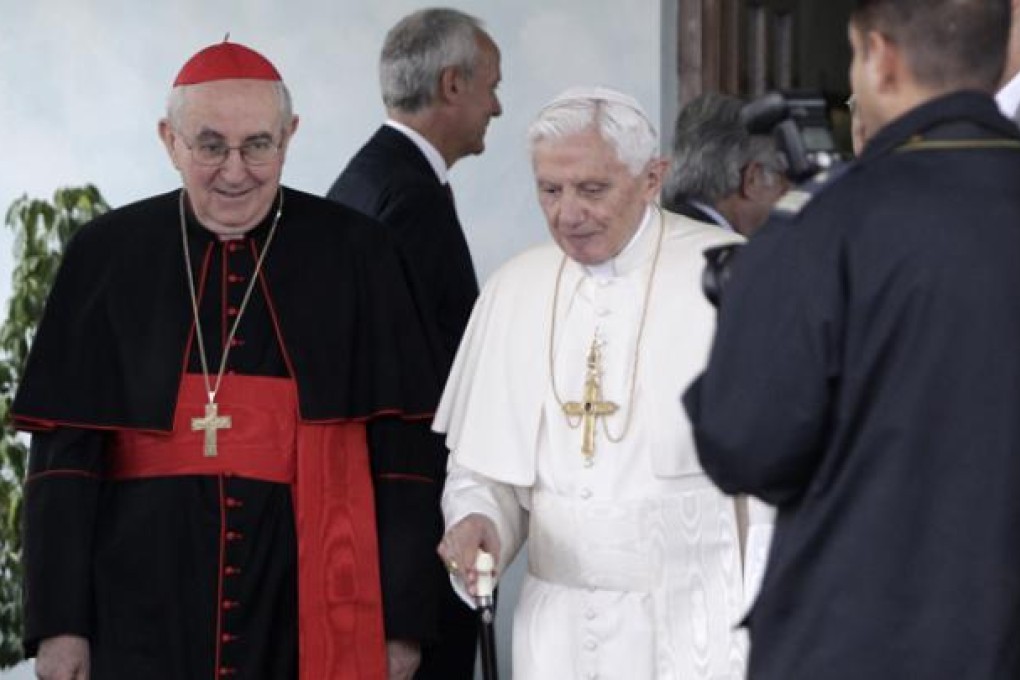 Pope Benedict XVI, center, with cardinal vicar Agostino Vallini, left, arrives to board a plane to Lebanon, at the Ciampino military airport, near Rome, on Friday. Photo: AP