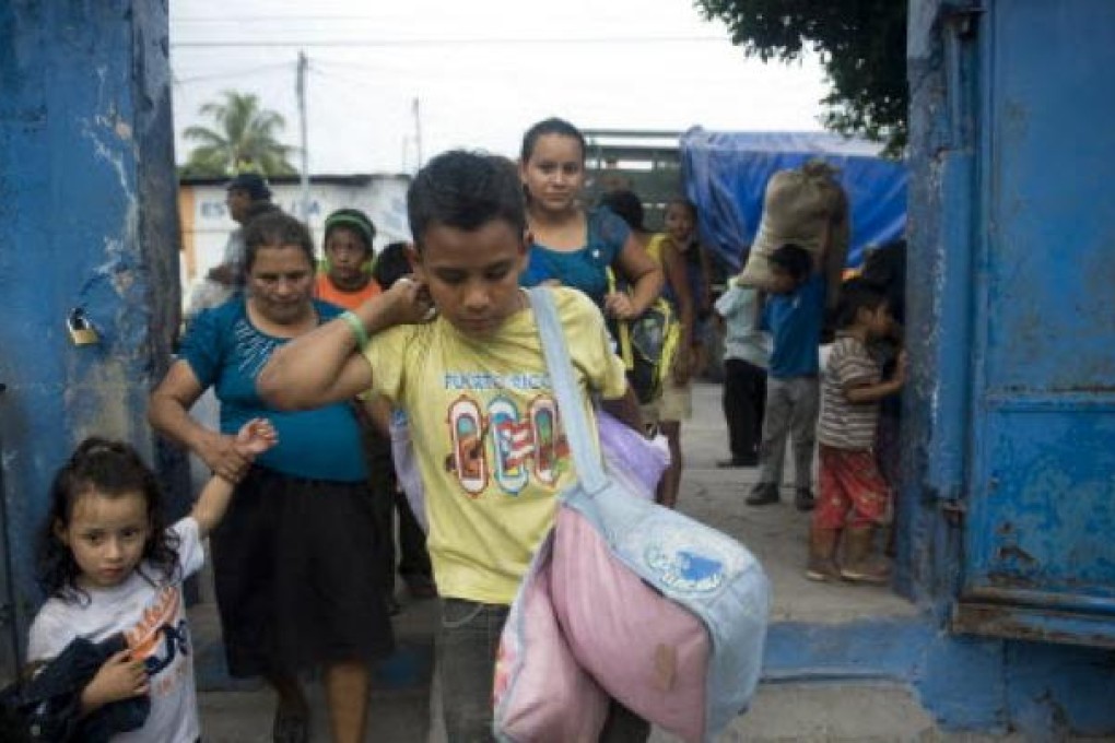 People evacuated from Morazan arrive at a shelter in a school of Santa Lucia Cotzumalguapa, 90km south of Guatemala City after their village was affected by ash released by the Volcan de Fuego. Guatemala's Volcano of Fire had its strongest eruption in a decade on Thursday. Photo: AFP