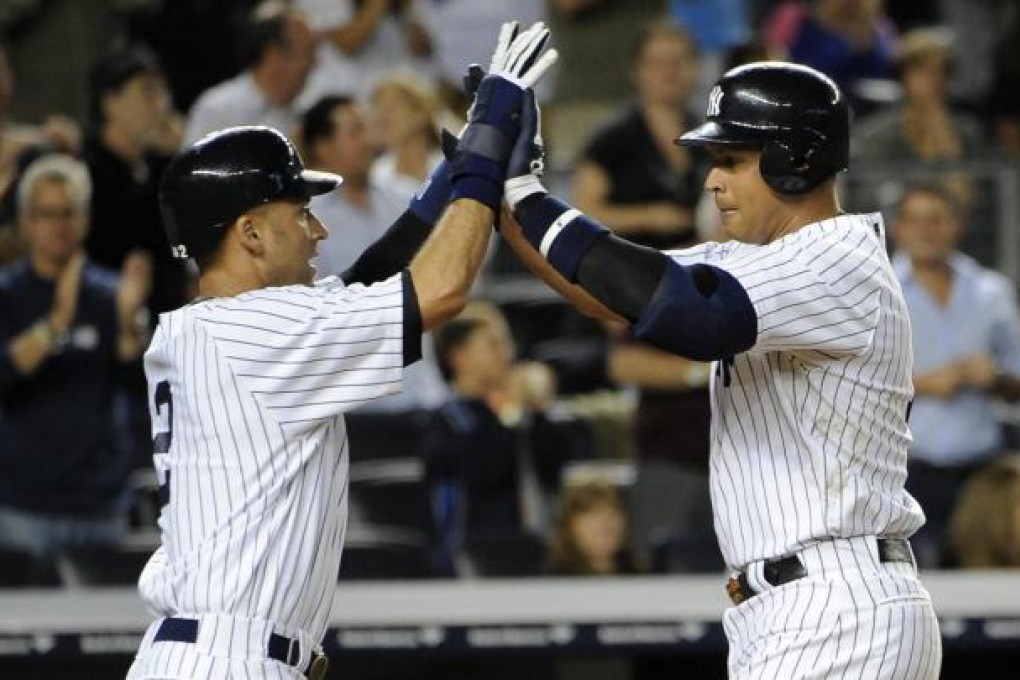 Derek Jeter greets Alex Rodriguez at home plate. Photo: AP