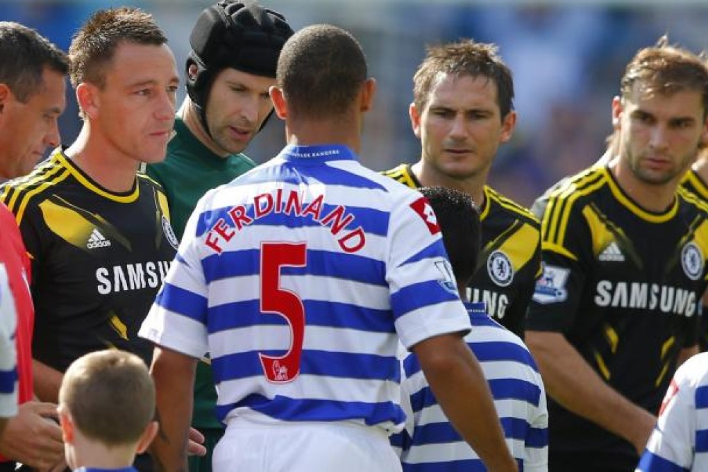 QPR's Anton Ferdinand walks past Chelsea's John Terry without shaking his hand before the start of their match yesterday. Photo: Reuters