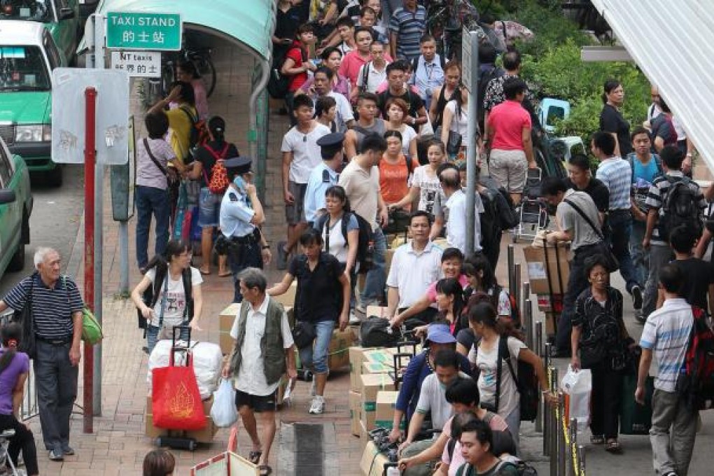 Travellers wait outside Sheung Shui station. Photo: Sam Tsang