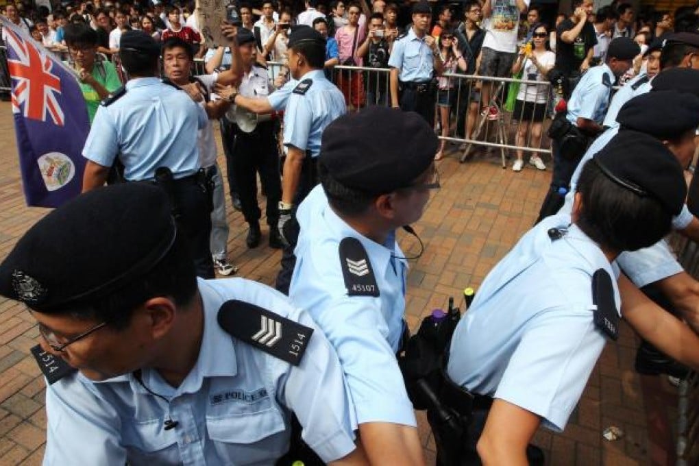 Protesters brandishing a modified colonial-era flag and a sign reading "Chinese people eat s**t" prompted an angry response from some at the scene. Photo: Felix Wong