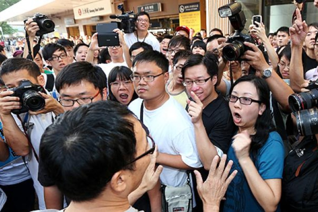 A supporter of parallel goods exporters argues with protesters outside the Sheung Shui railway station on Sunday. Photo: David Wong