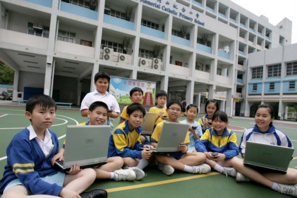 Students of Shak Chung Shan Memorial Catholic Primary School on their e-class in their school's sport ground in Tsuen Wan. Photo: Edward Wong