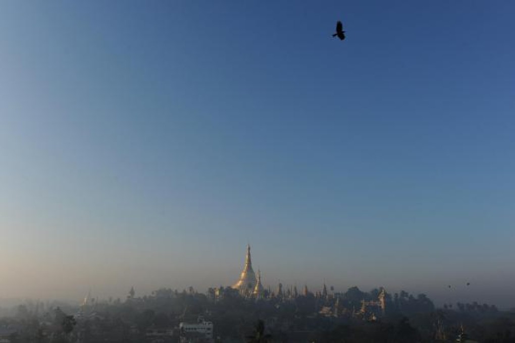The sun rises over the Shwedagon Pagoda in Yangon, symbolic of Myanmar's emergence from political and economic isolation since a civilian government took power last year after decades of military rule. With the West easing sanctions and businesses closely watching reform, Myanmar is preparing for an increase in investment and tourism. Photo: AFP