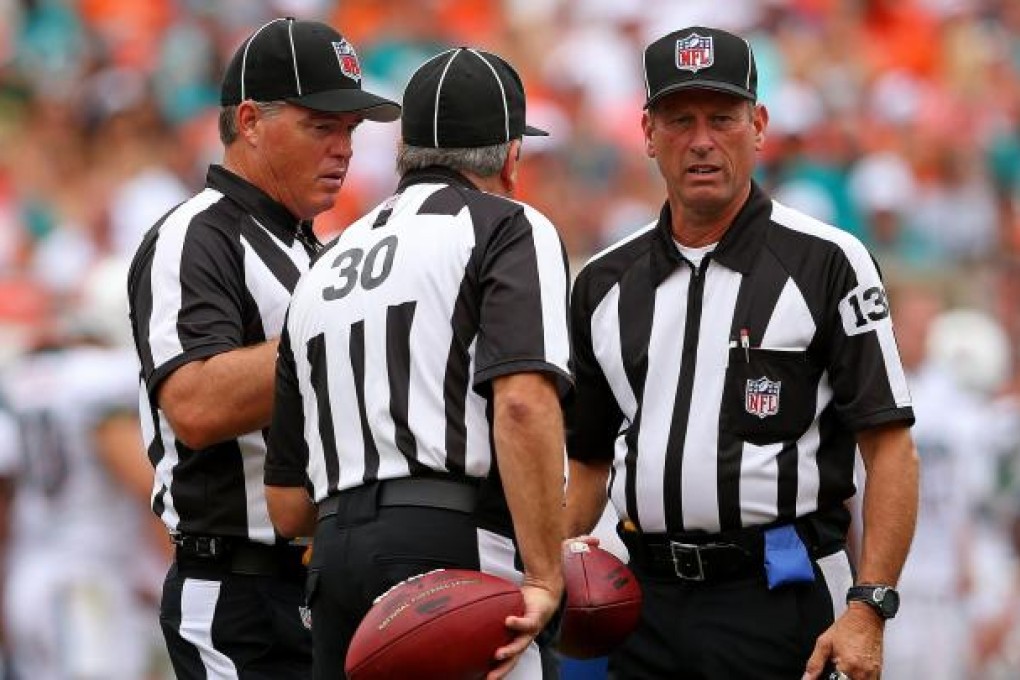 Replacement referees discuss a play during a game. Photo: AFP