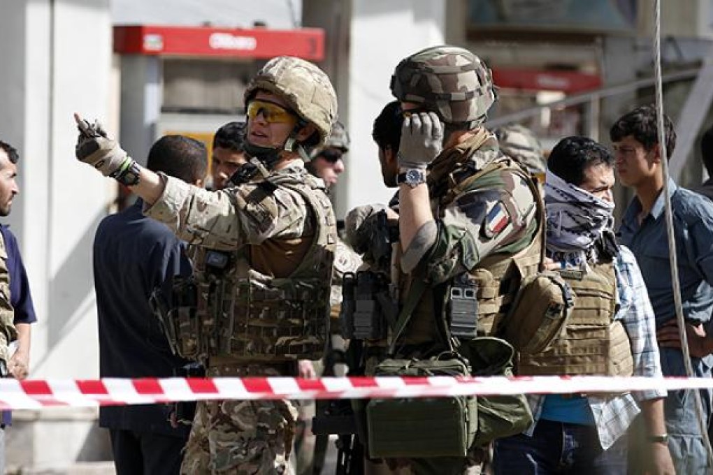 Nato troops arrive at the scene of a suicide bombing in Kabul on Tuesday. Photo: AP