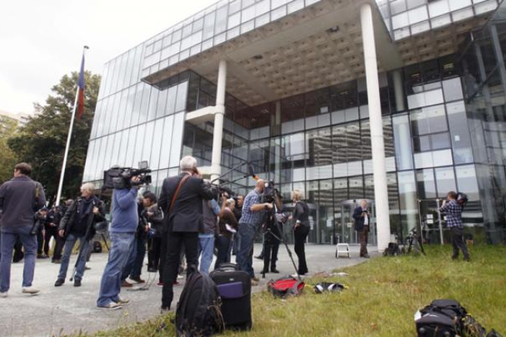 Members of the media gather outside a French court which ordered a magazine publisher to hand over all digital copies of topless photos of Britain's Duchess of Cambridge, in Nanterre, west of Paris, on Tuesday. Photo: AP