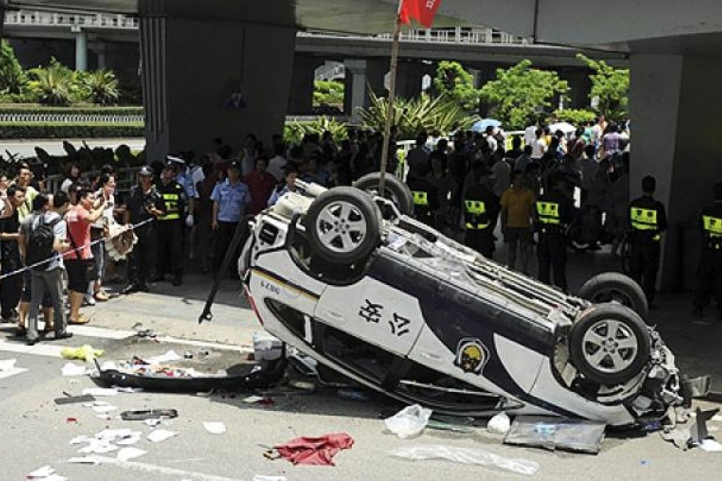 A police car made by Honda is smashed up by anti-Japan protesters in August. Honda Motor said it had temporarily closed all five of its China plants after violent demonstrations. Photo: AP