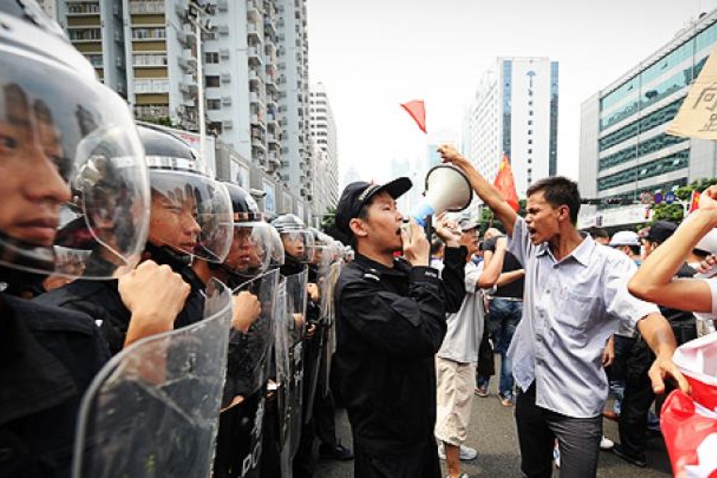 Protesters in Shenzhen go head-to-head with riot police on Tuesday. Photo: AFP
