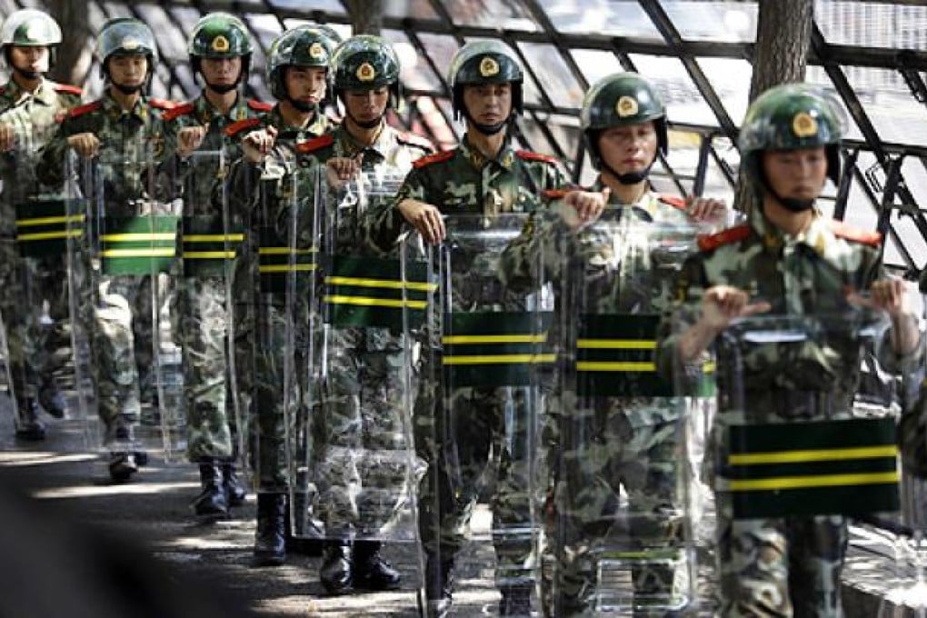 Paramilitary troops guard the Japanese embassy in Beijing on Wednesday, but protests have largely died down. Photo: AP